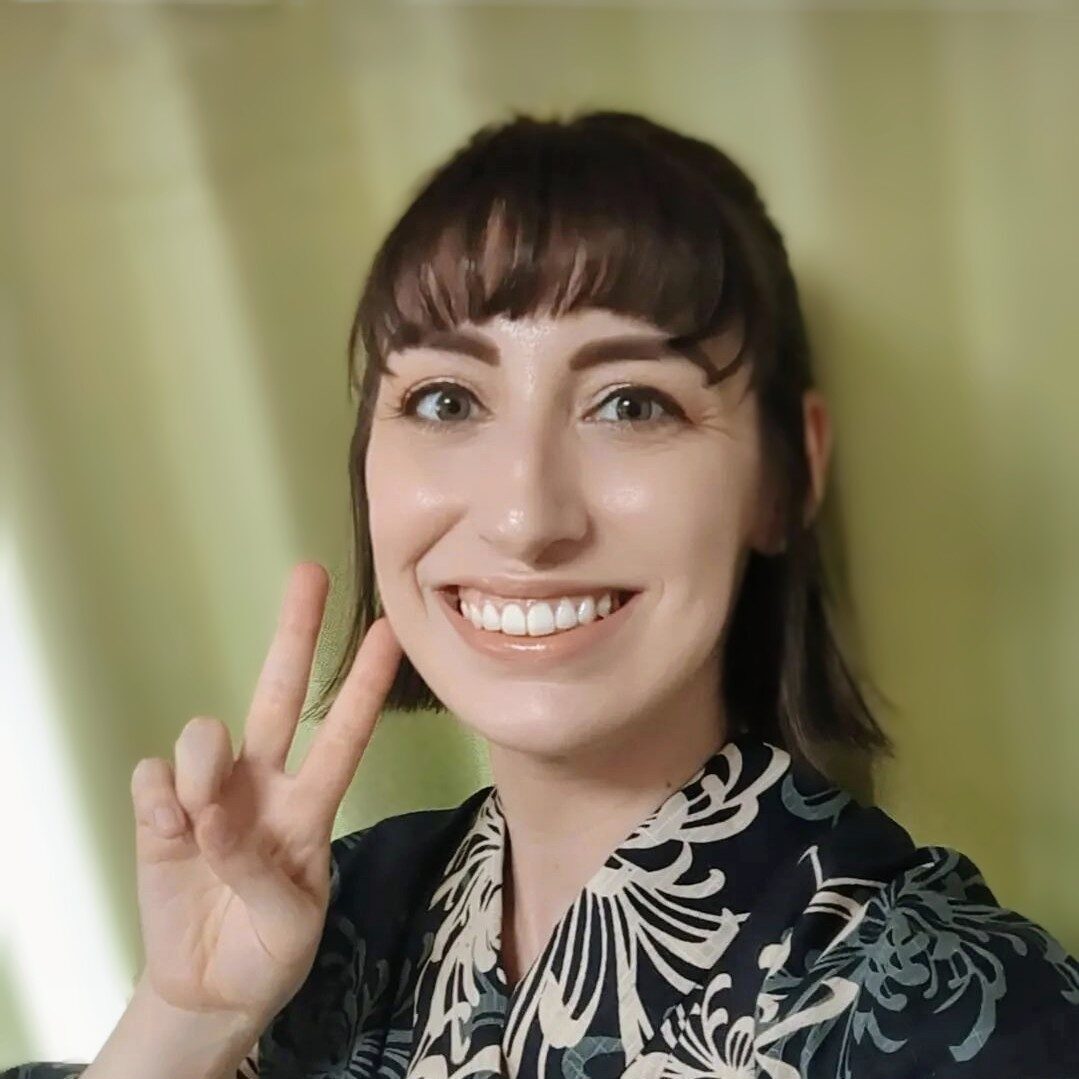 Brittany with short brown bob cut in a navy blue yukata doing the peace sign